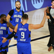 James Ennis III #11, Nikola Vucevic #9 and Terrence Ross #31 of the Orlando Magic celebrate after beating the Milwaukee Bucks in Game One in the first round of the NBA playoffs at The Field House at ESPN Wide World Of Sports Complex on August 18, 2020 in Lake Buena Vista, Florida.
